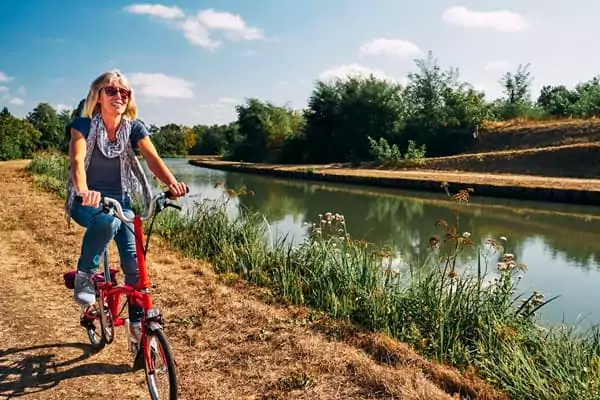 une femme se balade en vélo en bords de Loire.